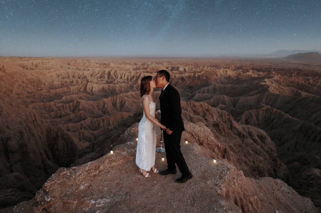 a couple kissing under the stars in the california desert