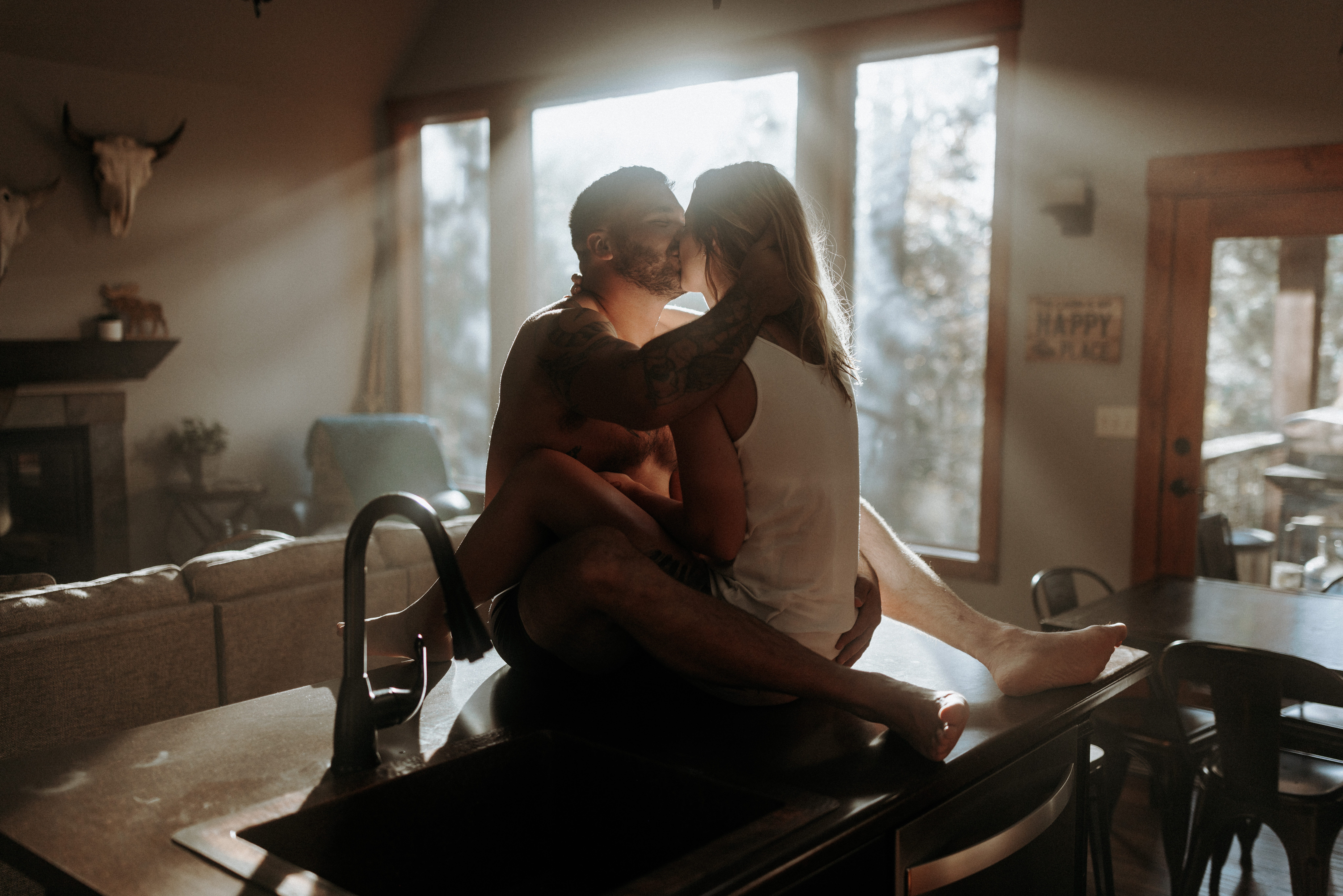 A man and woman on a kitchen counter in their underwear.
