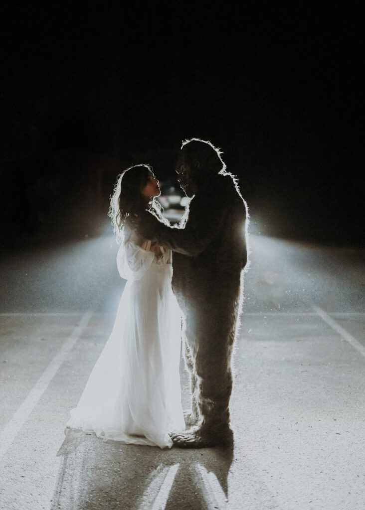A bride and her husband dressed as bigfoot share a first dance in Olympic National Park, a unique and unconventional elopement idea.