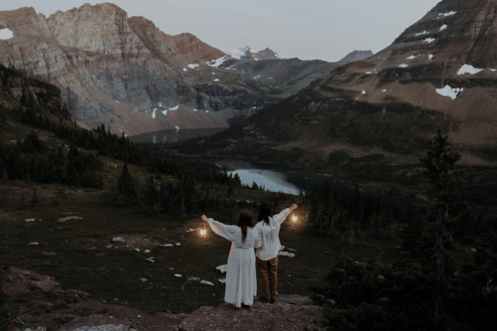 An elopement couple with lanterns at Logan Pass in Glacier National Park